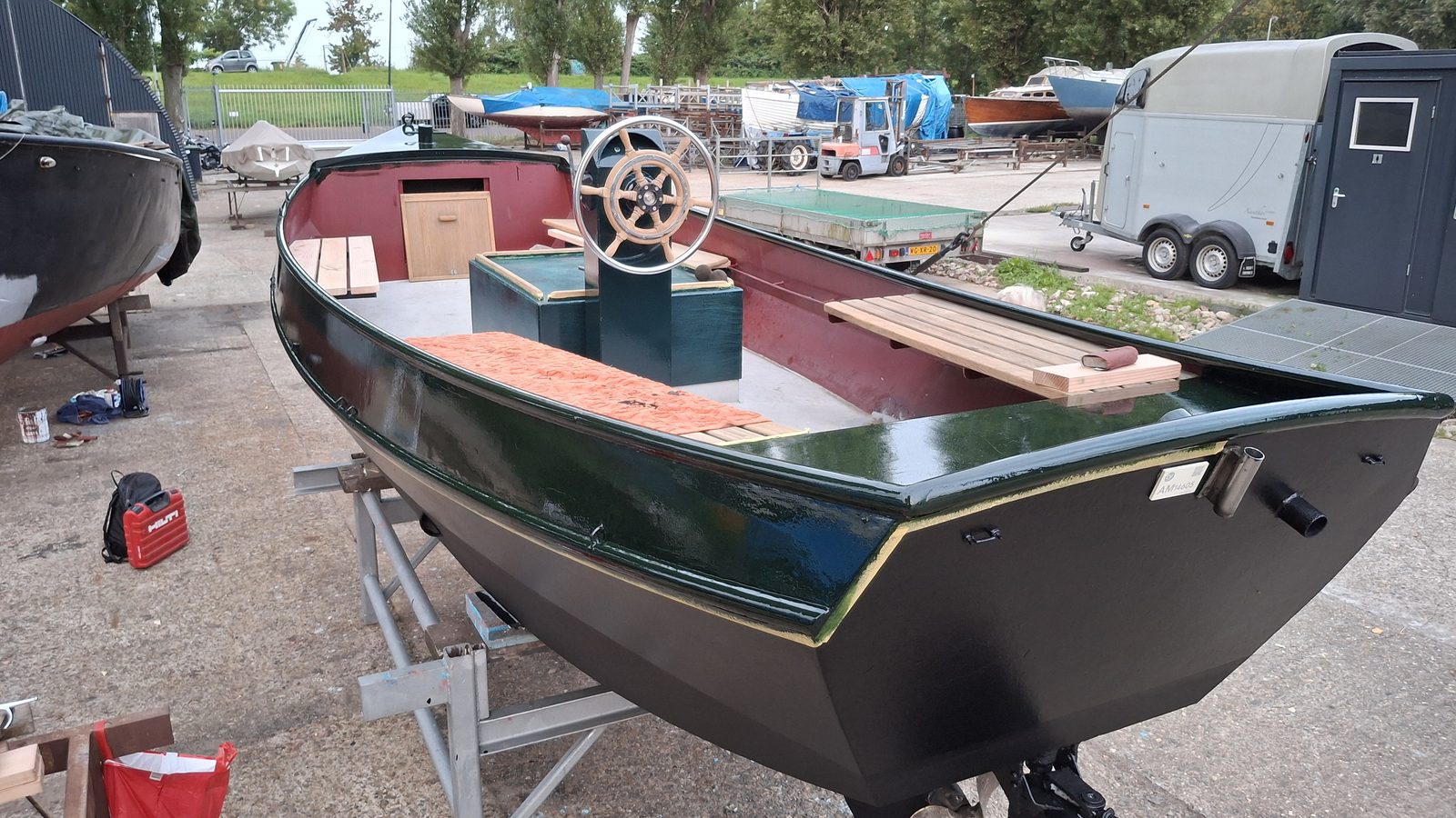 Open tender boat hull during restoration, primer coat and fit-out in progress